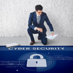 Man with paper in his hands next to banner cybersecurity whats on the floor