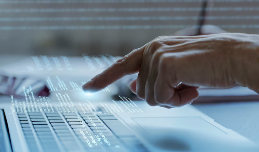 programming background with a person pressing the keyboard on the laptop