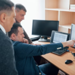 People discussing information in front of a computer
