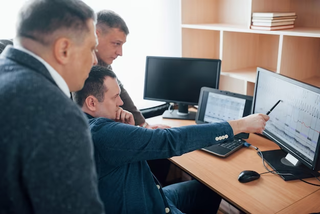 People discussing information in front of a computer