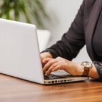 Woman typing on laptop in office