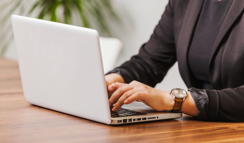 Woman typing on laptop in office