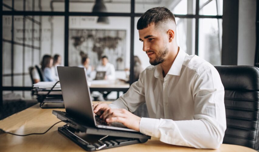 A man works on his laptop in the office