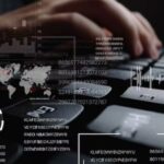 a black keyboard, figures, a map, and passwords, with hands typing in the background
